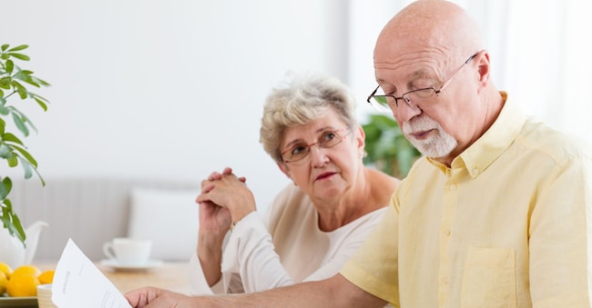 Elderly couple calculating costs of household. Senior people with low pension
