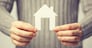 bright picture of man holding paper house