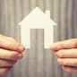 bright picture of man holding paper house