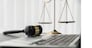 Symbolizing justice and legal authority, golden balanced scale and gavel on desk with laptop in law office background, reflecting concept of equality and fair judgment by lawyer and judge. equility