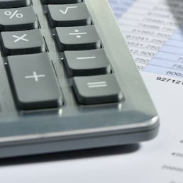 The calculator and the financial report. A workplace of the businessman