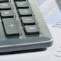 The calculator and the financial report. A workplace of the businessman