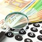 Euro Notes with calculator and magnifier. Closeup