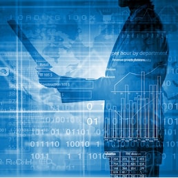 Back view of businessman and graphs at background