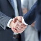 closeup of handshake of business partners on the background of business team