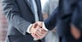 closeup of handshake of business partners on the background of business team