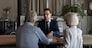 Male Caucasian specialist have meeting with mature couple clients, discuss health insurance for older people. Middle-aged spouses customers consult with relator or broker. Realty, rent concept.