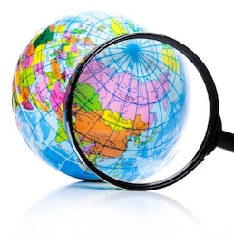 Globe under magnifying glass zooming Russia and China on white background