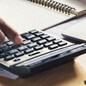 businessman working on desk with using calculator and computer in office. concept accounting finance