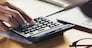 businessman working on desk with using calculator and computer in office. concept accounting finance