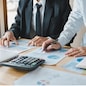 Business people working together at office room table and balancing budget.