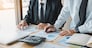 Business people working together at office room table and balancing budget.
