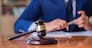 Handsome judge with gavel sitting in courtroom