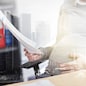 pregnancy, business and work concept - smiling pregnant businesswoman sitting at office table and reading papers over urban double exposure effect