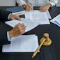 Legal counsel presents to the client a signed contract with gavel and legal law. justice and lawyer concept.