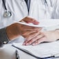 Doctor or physician writing diagnosis and giving a medical prescription to male Patient