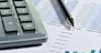 The calculator and the financial report. A workplace of the businessman