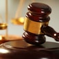 Wooden judges gavel on wooden table, close up