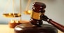 Wooden judges gavel on wooden table, close up