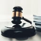 Black wooden gavel hammer and legal document in empty law firm or lawyer office background as justice and legal system for lawyer and judge, Legal authority and fairness in trials concept. equility