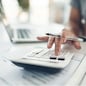 Finance planning, budget or savings manager calculating expenses, taxes or company profits with laptop, paperwork or calculator. Closeup hands of female financial leader checking office staff payroll.