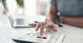 Finance planning, budget or savings manager calculating expenses, taxes or company profits with laptop, paperwork or calculator. Closeup hands of female financial leader checking office staff payroll.