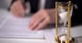 Closeup of sand clock measuring time, official signing important reform document, stock footage