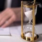 Closeup of sand clock measuring time, official signing important reform document, stock footage