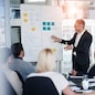 Man, meeting and whiteboard with staff in office for workflow steps, diagram or teamwork for web design. Male presenter, developer and meeting of strategy process, chart and interface idea proposal.