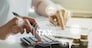 women using calculator calculated individual income tax for pay taxes annual.Financial research,government taxes and calculation tax return concept. Tax and Vat concept.