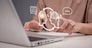 Human and AI interaction in modern technology. A person using a laptop with virtual assistant and deep learning, representing intelligent automation and innovation. digital assistant conversation