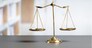 Shiny golden balanced scale in court library background as concept justice and fairness legal symbol. Scale balance for righteous and equality judgment by lawyer and attorney. equility
