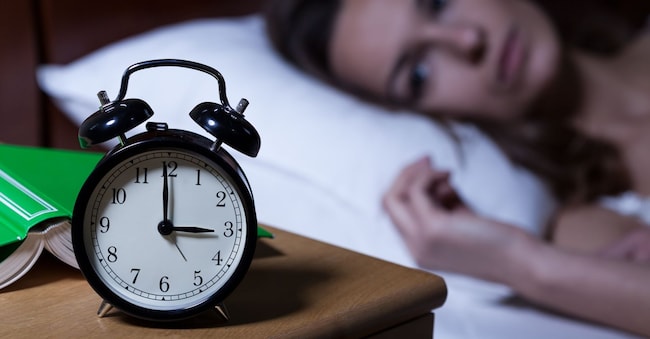 Alarm clock on night table showing 3 a.m. Photographee.eu - stock.adobe.com