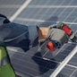 Engineer in a white helmet. Man near solar panel.
