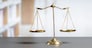 Shiny golden balanced scale in court library background as concept justice and fairness legal symbol. Scale balance for righteous and equality judgment by lawyer and attorney. equility