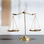 Shiny golden balanced scale in court library background as concept justice and fairness legal symbol. Scale balance for righteous and equality judgment by lawyer and attorney. equility