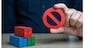 Shipping containers and prohibition symbol NO. Ban on import of goods. Sanctions and embargoes. Trade wars. Container shortage crisis. Blocking of cargo and blockade of trade routes.
