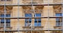 Photo of an old building during the moment of restoration of a facade