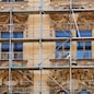 Photo of an old building during the moment of restoration of a facade