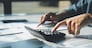 women using calculator calculated individual income tax for pay taxes annual.Financial research,government taxes and calculation tax return concept. Tax and Vat concept.