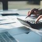 women using calculator calculated individual income tax for pay taxes annual.Financial research,government taxes and calculation tax return concept. Tax and Vat concept.