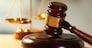 Wooden judges gavel on wooden table, close up
