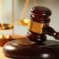 Wooden judges gavel on wooden table, close up