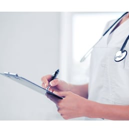 healthcare and medical concept - female doctor with stethoscope writing prescription