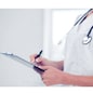 healthcare and medical concept - female doctor with stethoscope writing prescription