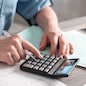 Female accountant using calculator in office