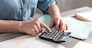 Female accountant using calculator in office