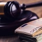 Judge's hammer gavel. Justice and euro money. Euro currency. Court gavel and rolled Euro banknotes. Representation of corruption and bribery in the judiciary.