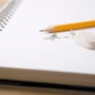 pencil, eraser and eraser leftovers on notebook