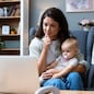 Young female business owner work on laptop from home during maternity leave, running private company with baby in her lap. Businesswoman mother woman with a toddler working at the computer.
